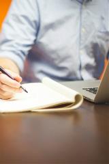 writingonnotepadwithlaptop